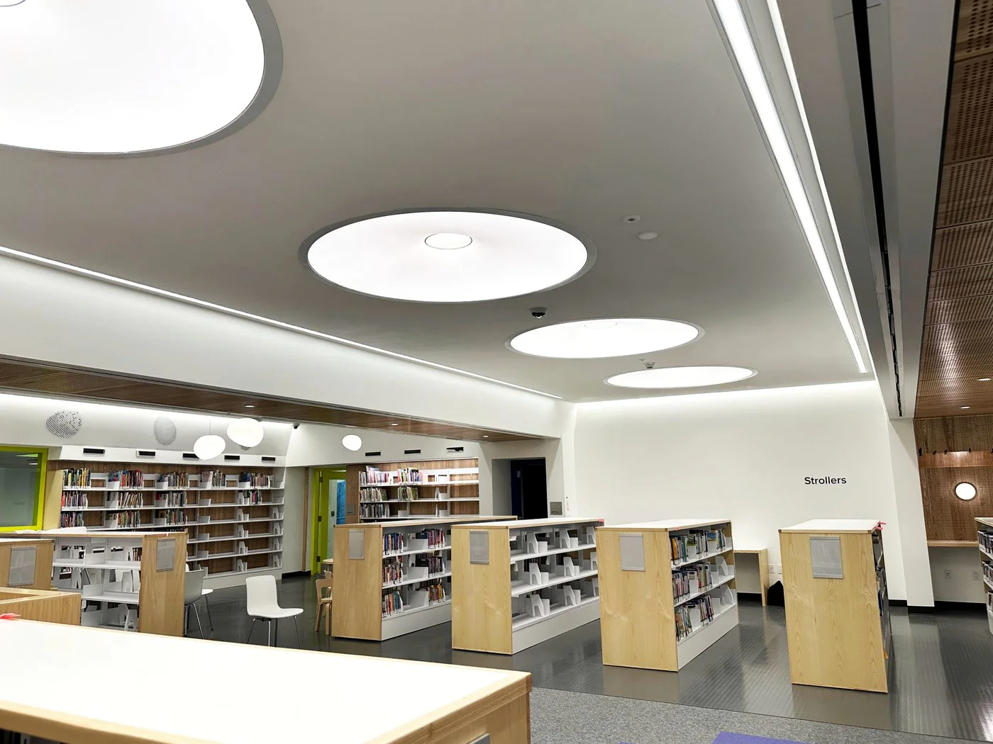 Library interior with custom round light guide ceiling panels